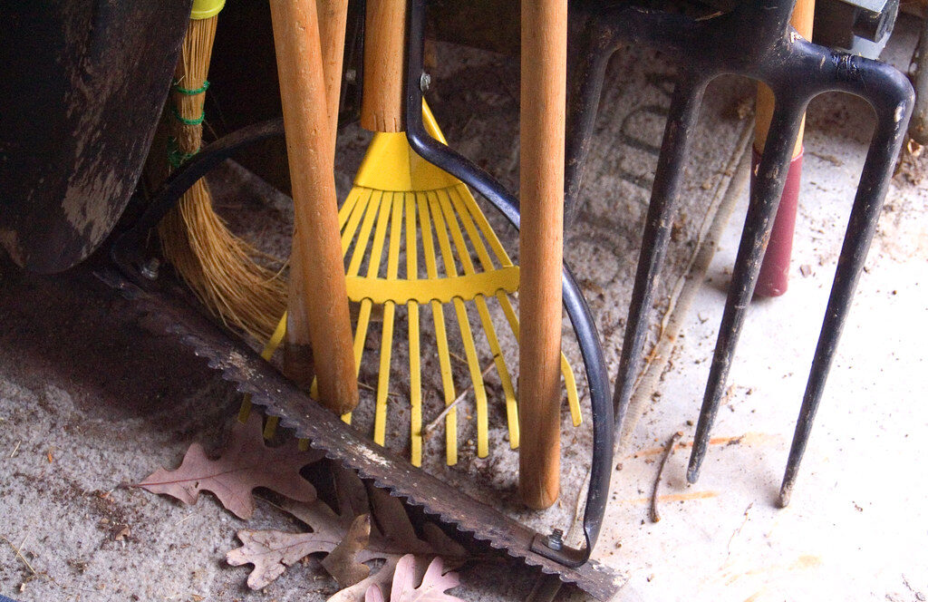Close-up of garden rake, fork and hand tools ready for a tidy-up job